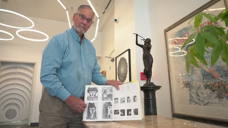 Art dealer Bill DeLind shows a picture of a Pablo Picasso sketch (upper left) stolen from his shop DeLind Fine Art Appraisals in 2018 in Milwaukee on August 14, 2026. The sketch was recently found in town.