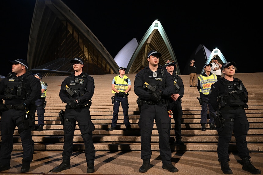 Police in uniform line the forecourt steps of the Sydney Opera House with building in background