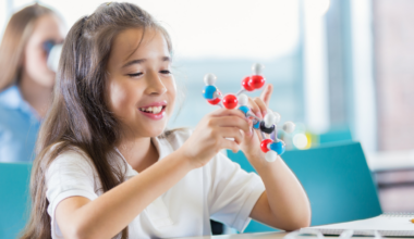 A fifth-grader in Kansas City clicked ball-and-stick atoms together in science class and asked her teacher if she'd made a real molecule — he photographed it, sent it to a chemistry professor, and at ten years old she became co-author of a published paper on a structure nobody had ever described