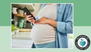 Pregnant person looking at phone