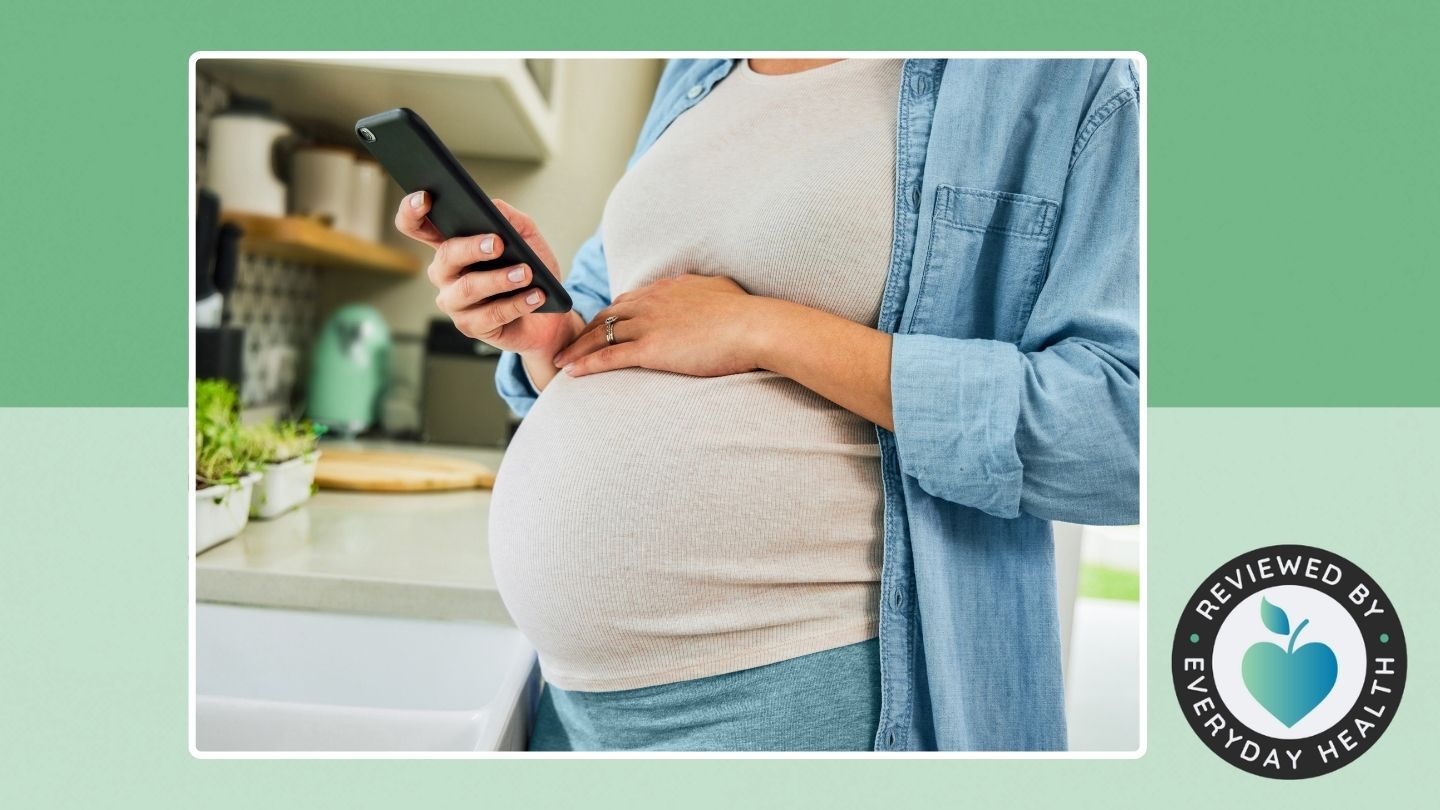 Pregnant person looking at phone