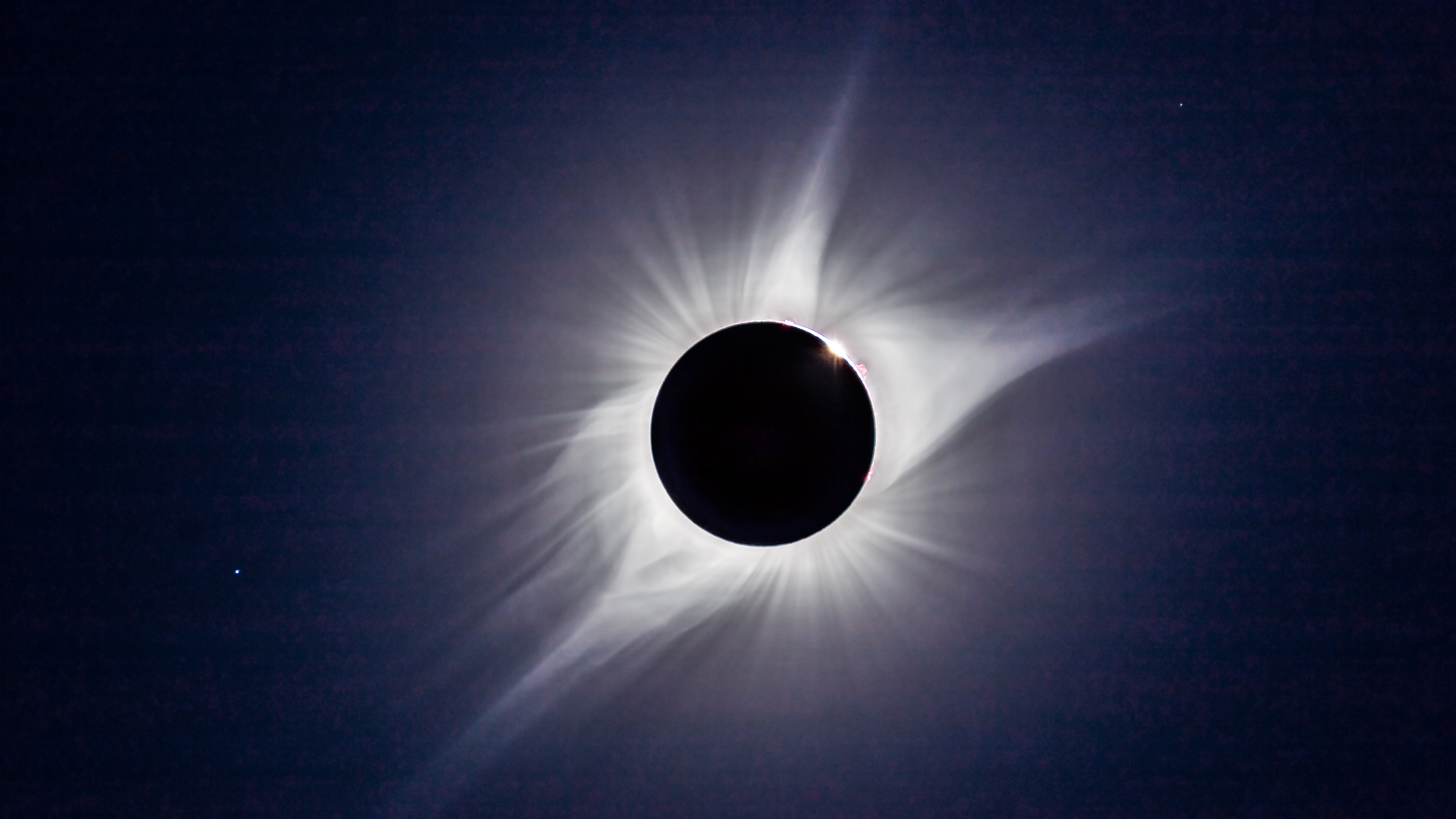 A composite of the August 21, 2017 total solar eclipse showing third contact &ndash; the end of totality &ndash; with sunlight beginning to reappear and the array of pink prominences along the limb of the Sun Seconds later the emerging Sun and diamond ring overwhelmed the large prominence Regulus is at lower left This is a composite of two images taken seconds apart: a 1/15th second exposure for the corona and a 1/1000 sec exposure for the prominences and chromosphere Taken with the 106mm Astro-Physics apo refractor at f/5 and Canon 6D MkII camera at ISO 100 On the Mach One equatorial mount, polar aligned and tracking the sky. (