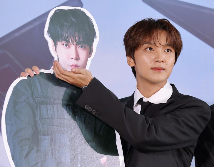 Haechan of boy band NCT 127 poses with a standee of bandmate Doyoung during a press conference at SKY31 in Seoul's Songpa District, Monday, marking the release of the group's seventh full-length album, 'BLINGY.' Yonhap