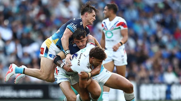 Chanel Harris-Tavita of the Warriors is tackled during the round 22 NRL match between Gold Coast Titans and New Zealand Warriors.