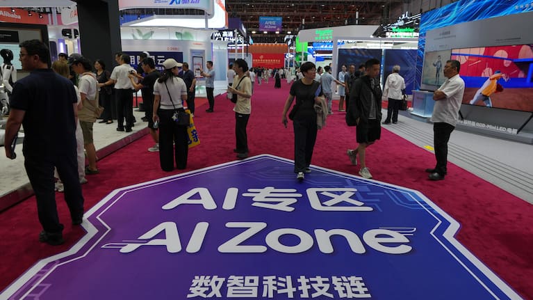 Visitors tour the exhibition booths operated with Artificial Intelligence (AI) at the China International Supply Chain Expo in Beijing