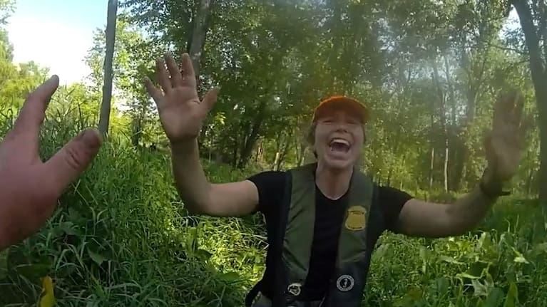 Conservation officer Anna Cullen celebrating in Twin Lake, Michigan, as a search and rescue team found two women and a child who had been missing after taking a river tubing trip. (Source: Michigan Department of Natural Resources)