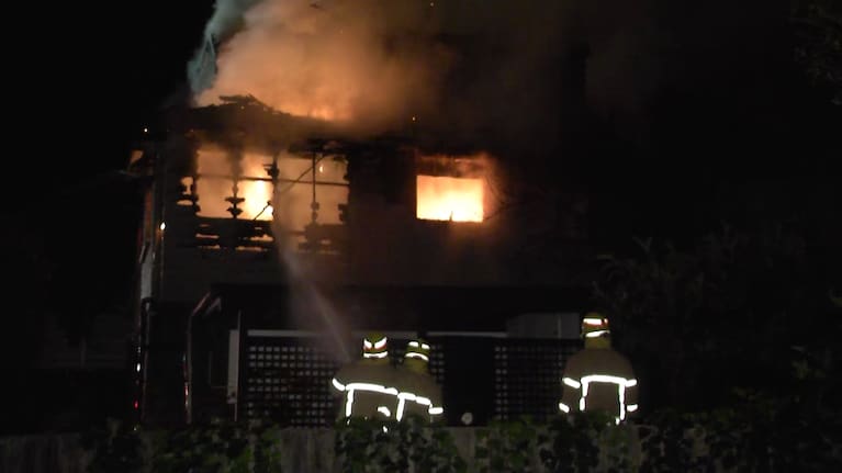 Crews work to put out the flames in Auckland's Buckland's Beach.