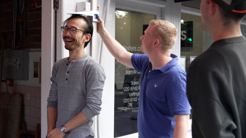 Dinner for One Hundred co-founders Jake Bucknall and Jacob Stuttard measure a singles’ night participant to ensure he is below the 6-foot limit.