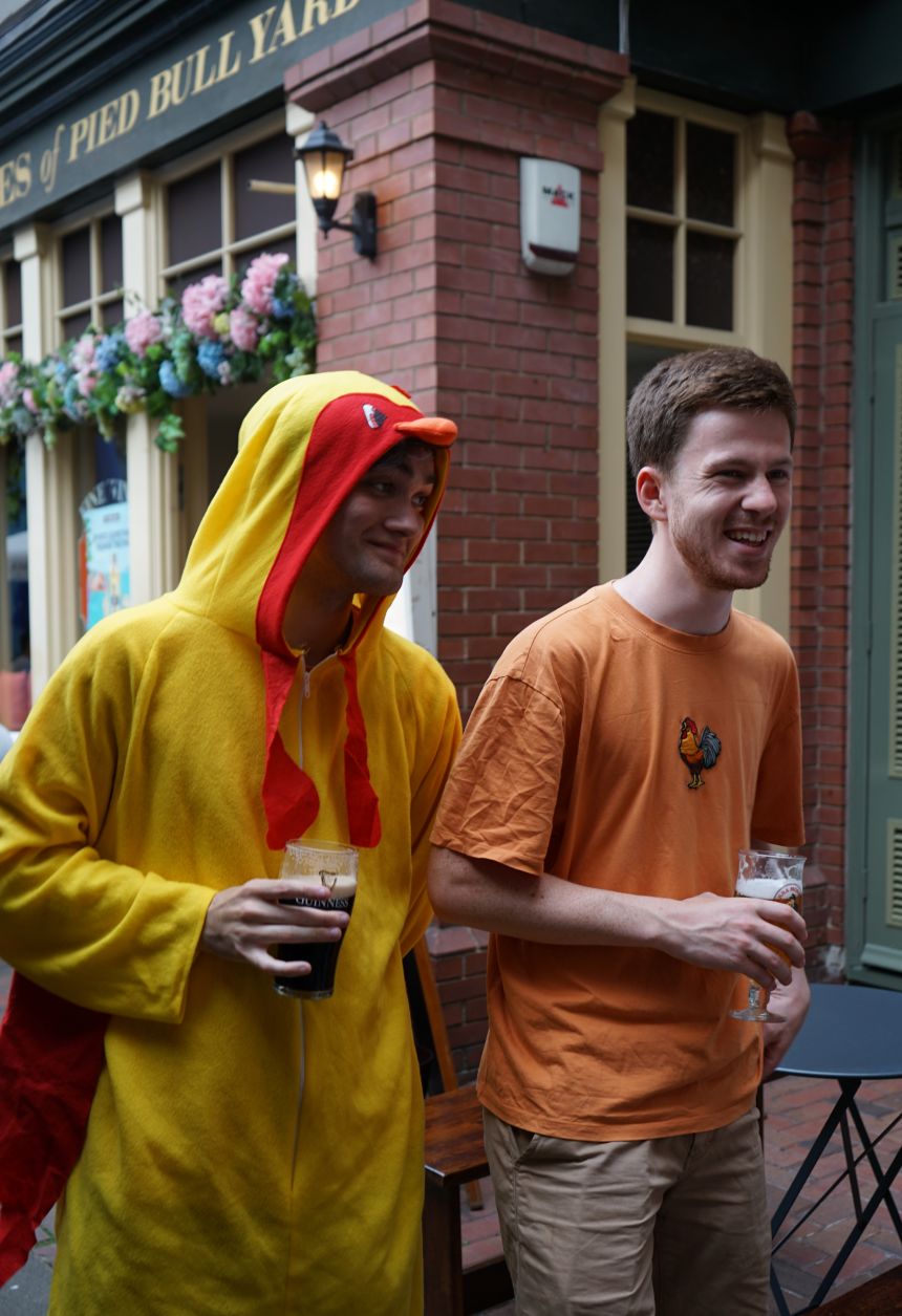 Chicken Rush founder Fred Parry (right) chats with the winning team at the final hiding spot, alongside one of the chicken-suited volunteers.
