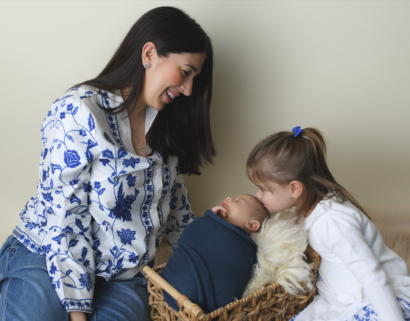 Mother and two children in a cozy setting, interacting closely.