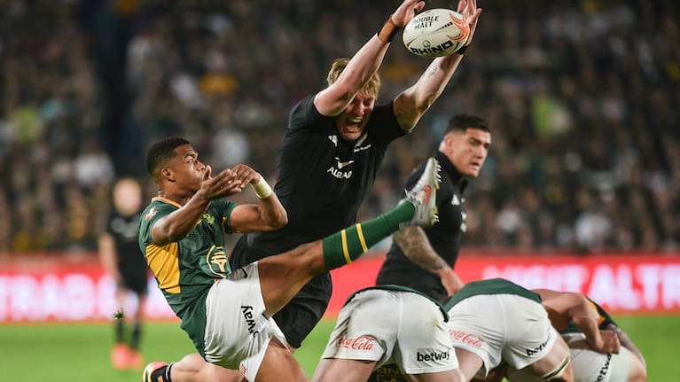 Fabian Holland charges down Grant Williams' clearing kick at Ellis Park.