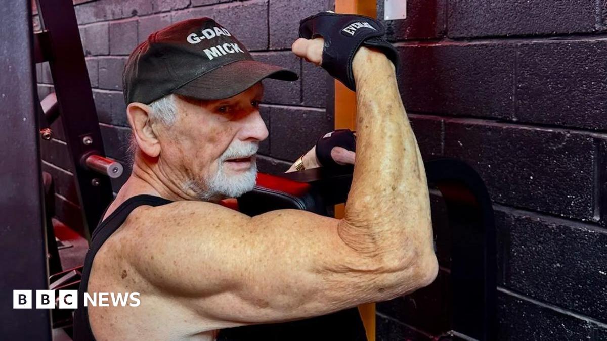 Mick Wadge flexes his right arm while using a weight-training machine at the gym.