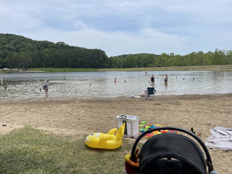 People play in a lake that has shrunk