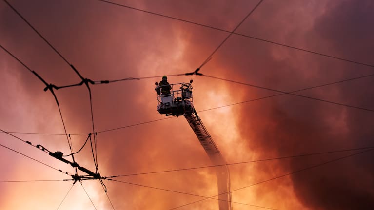 Firefighters try to put out a fire at a city book market following a Russian missile attack in Kyiv, Ukraine.