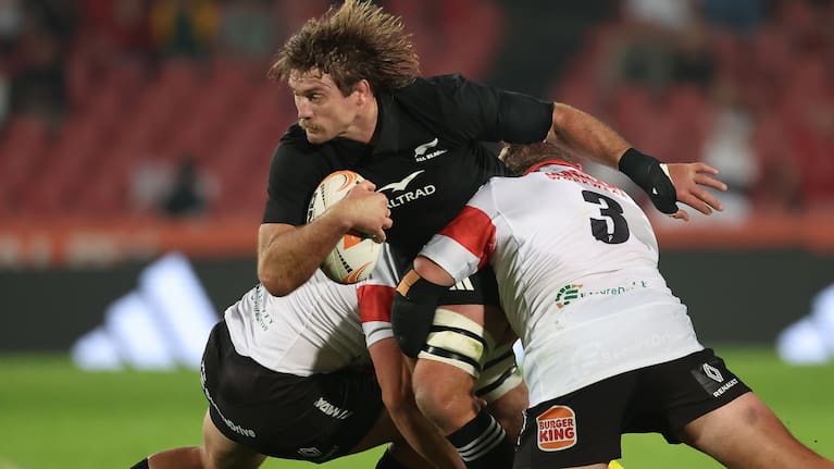 Flanker Ethan Blackadder is brought down by the Lions defence during the All Blacks' win.