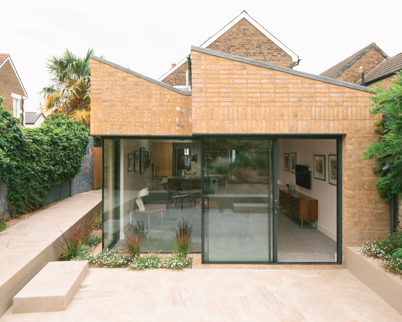sawtooth roof and textured brick facade reimagine victorian home in the uk - 1