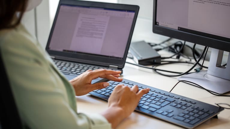 A woman tying on a computer (file image).