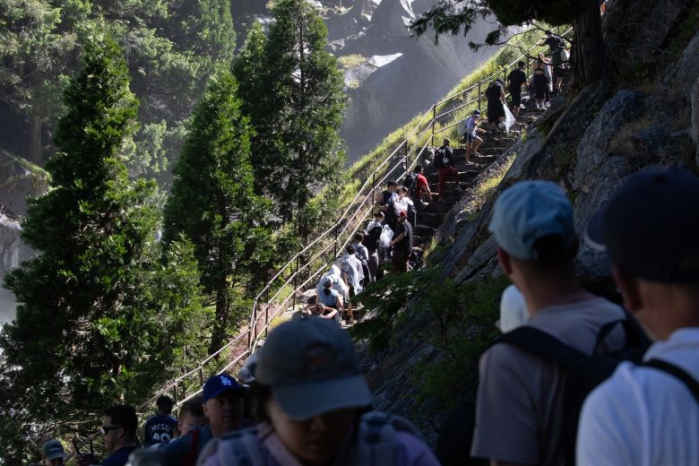 Tourists climb up the mist trail, one of the more popular hikes in California's Yosemite National Park, on June 13.