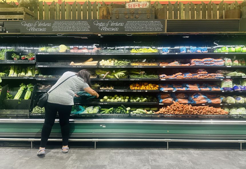 A woman shops for produce at a supermarket in La Puente, California, on August 7. The US lost thousands of jobs in July, government data showed, weakening President Donald Trump's claims of leading an economic revival.