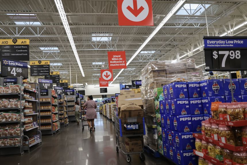 Items for sale are seen in a Walmart store. The nation's largest retailer got $2.9 billion in tariff refunds, and said it will lower prices. But it also reported sluggish sales due high gas prices squeezing consumers.
