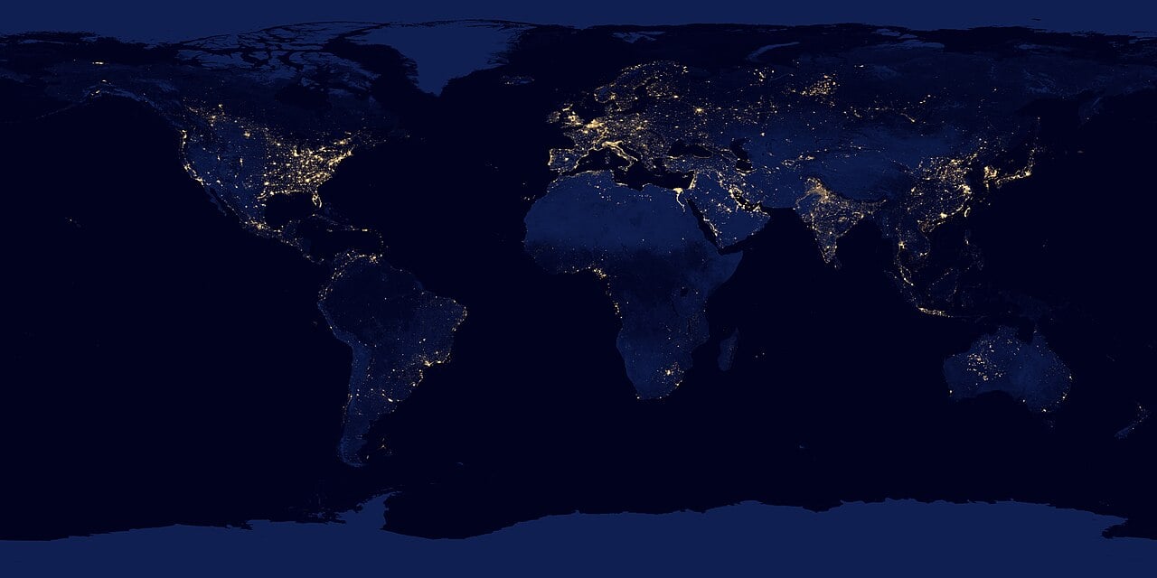 Earth at night, its city lights tracing the footprint of human civilization. Industry leaves atmospheric technosignatures an alien astronomer might detect. Credit: NASA (public domain).