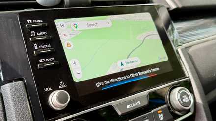 Telling Google Assistant to get directions to a person's address in Android Auto.