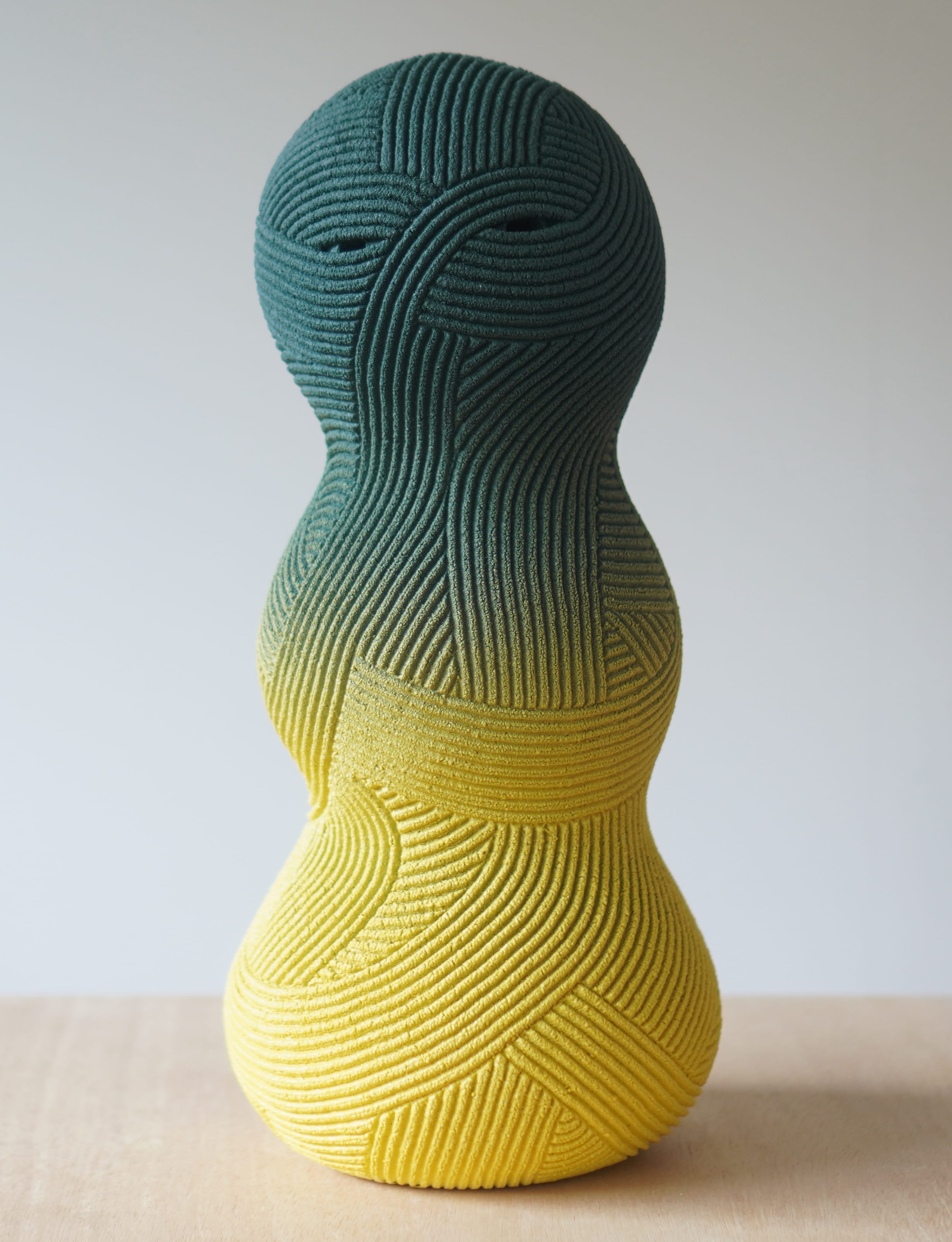 an abstract ceramic sculpture by en iwamura with a tiny face