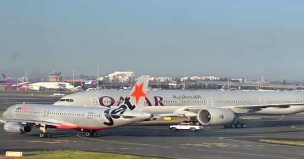 Two planes have near-miss at Sydney Airport, crew member injured