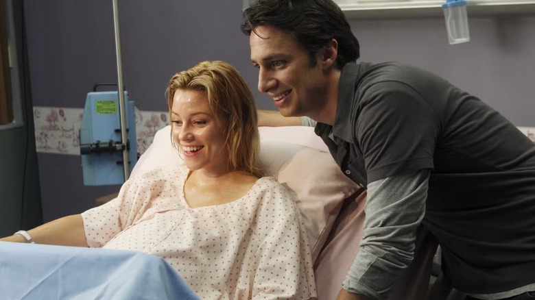 Kim and JD smiling after Kim has given birth in 