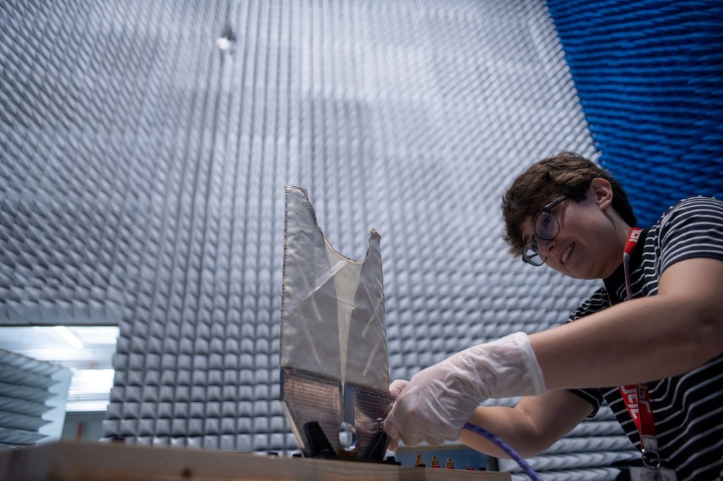 A radar engineer works on a test antenna for the SkyFall mission&rsquo;s ground-penetrating radar in the electromagnetic interference chamber at JPL.