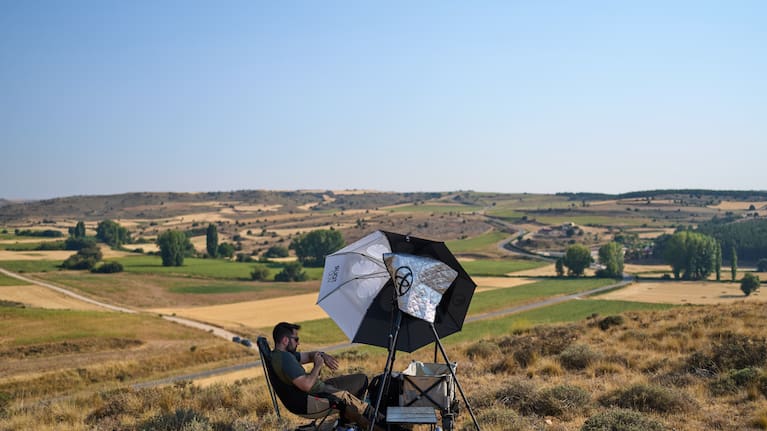 Mario Garrido, a member of the "Los Taraos" amateur astrophotography group, waits to shoot a total solar eclipse in Berlanga de Duero, central Spain.