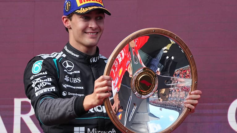 Mercedes driver George Russell of Britain celebrates on the podium with his trophy after winning the Australian Formula One Grand Prix