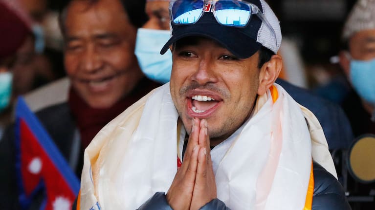 Nirmal Purja, one of the team member of the all-Nepalese mountaineering team that became the first to scale Mount K2 in winter, gestures as the team arrives at Tribhuwan International airport in Kathmandu, Nepal