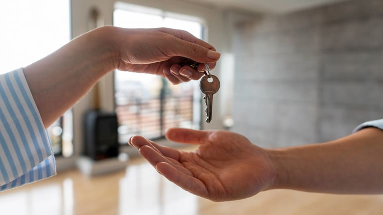 One person giving a key to another person (file image).