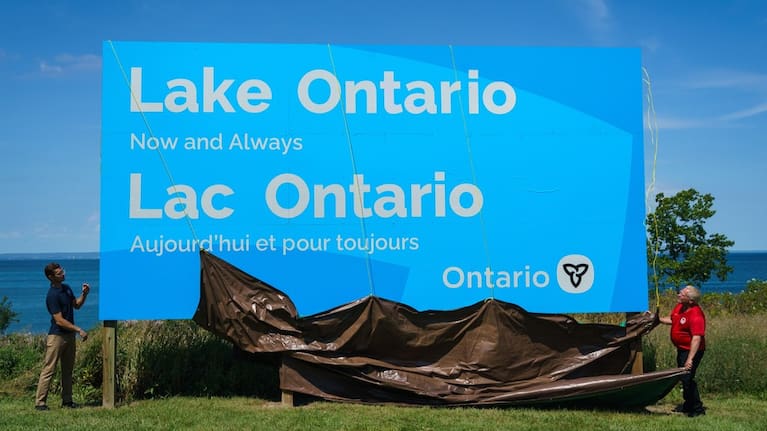 Ontario Premier Doug Ford and Niagara West Member of Provincial Parliament Sam Oosterhoff unveil a sign for Lake Ontario at the Fifty Point Conservation Area in Grimsby, Ontario.
