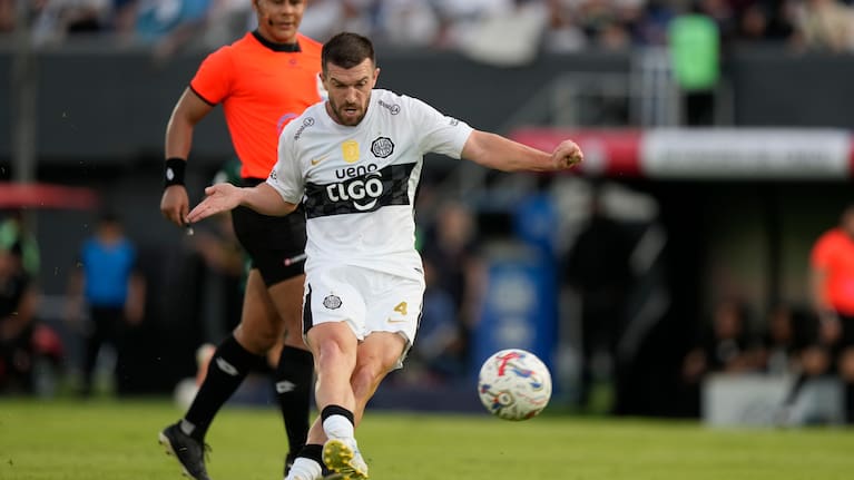 Olimpia's Tim Payne, of New Zealand, kicks the ball to score during his debut for the club at a Paraguayan soccer league match against Rubio Nu in Asuncion, Paraguay