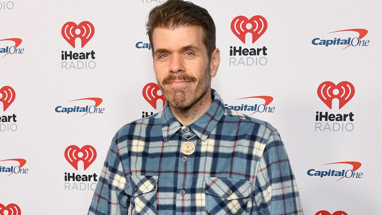Perez Hilton in a plaid shirt at an iHeartRadio event