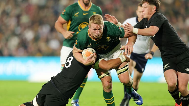 Pieter-Steph du Toit is brought down by Ardie Savea, left, and Cam Roigard.