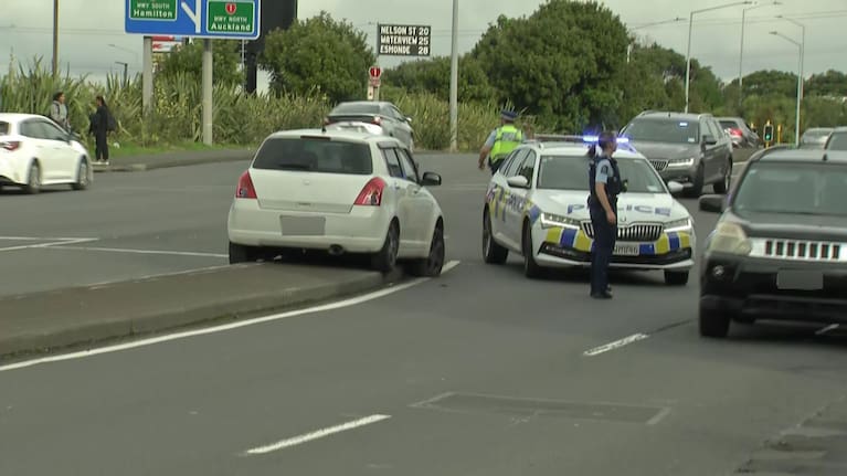 Police surround a white car at Auckland's Sylvia Park.
