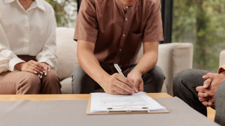 A person signing a house purchase agreement (file image).