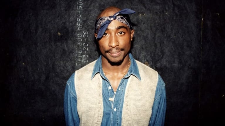 Rapper Tupac Shakur poses for photos backstage after his performance at the Regal Theater in Chicago, Illinois in March 1994.