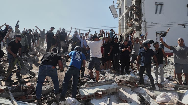 Residents and rescue workers search through the rubble of a collapsed building after an earthquake struck Cali, Colombia.