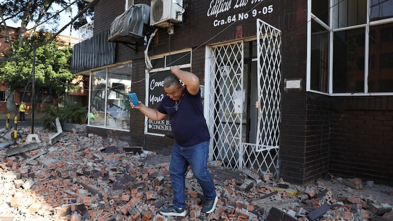 Residents and rescue workers search through the rubble of a collapsed building after an earthquake struck Cali, Colombia.