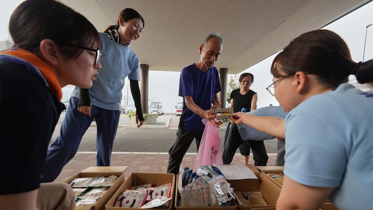 Residents receive food supply following an earthquake in Hikawa, Kumamoto Prefecture, southern Japan, Thursday, July 30, 2026.