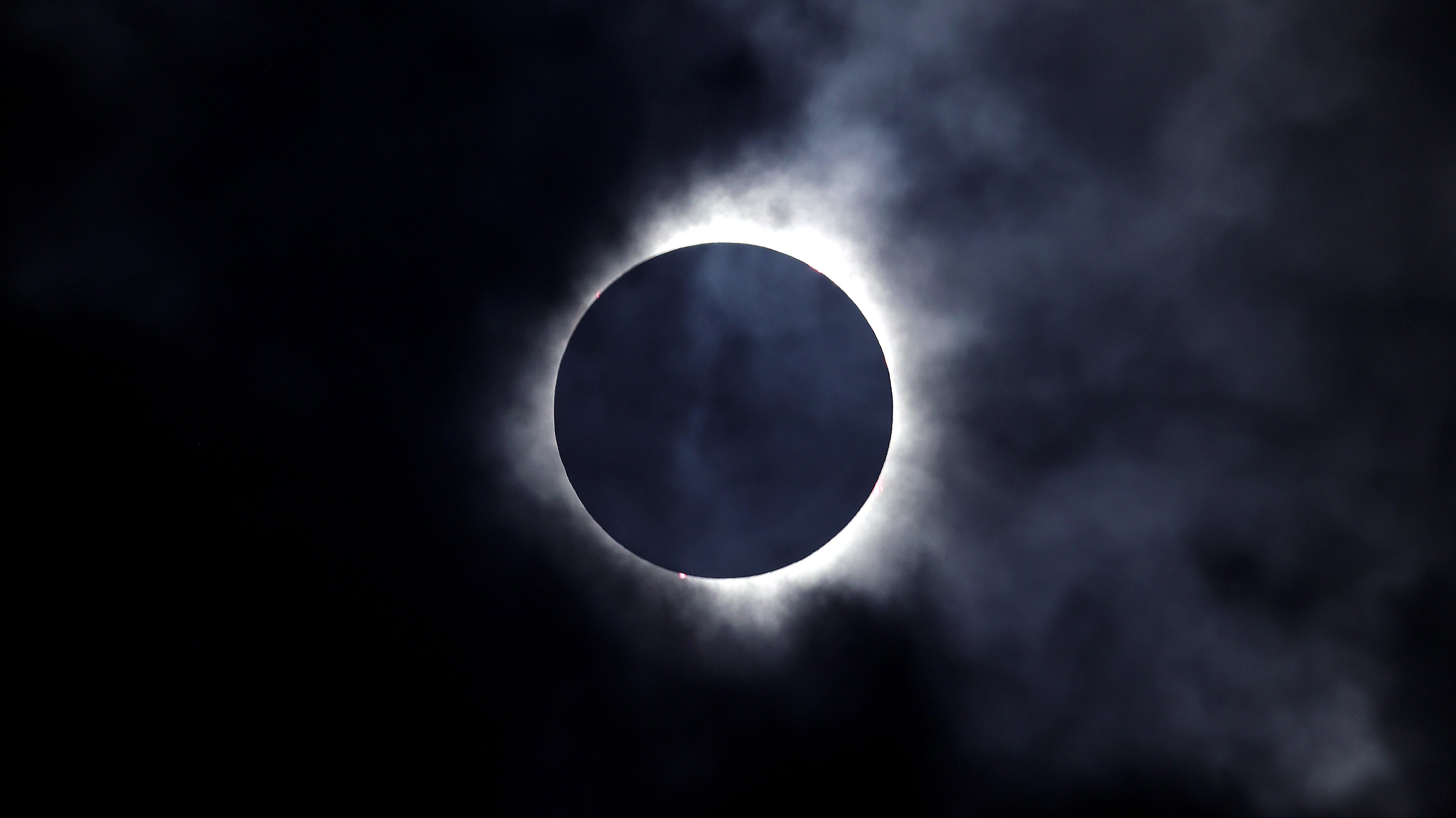 A solar eclipse is seen through the clouds on April 8, 2024 in Niagara Falls, Ontario, Canada.