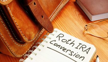 A spiral-bound notebook with 'Roth IRA Conversion' handwritten in black ink is open on a light brown wooden desk. To the left, a portion of a brown leather satchel or briefcase with a strap is visible. A black marker rests near the bottom right of the notebook. In the upper right corner, a small, dark brown book and a pair of gold-rimmed reading glasses are placed on the desk.