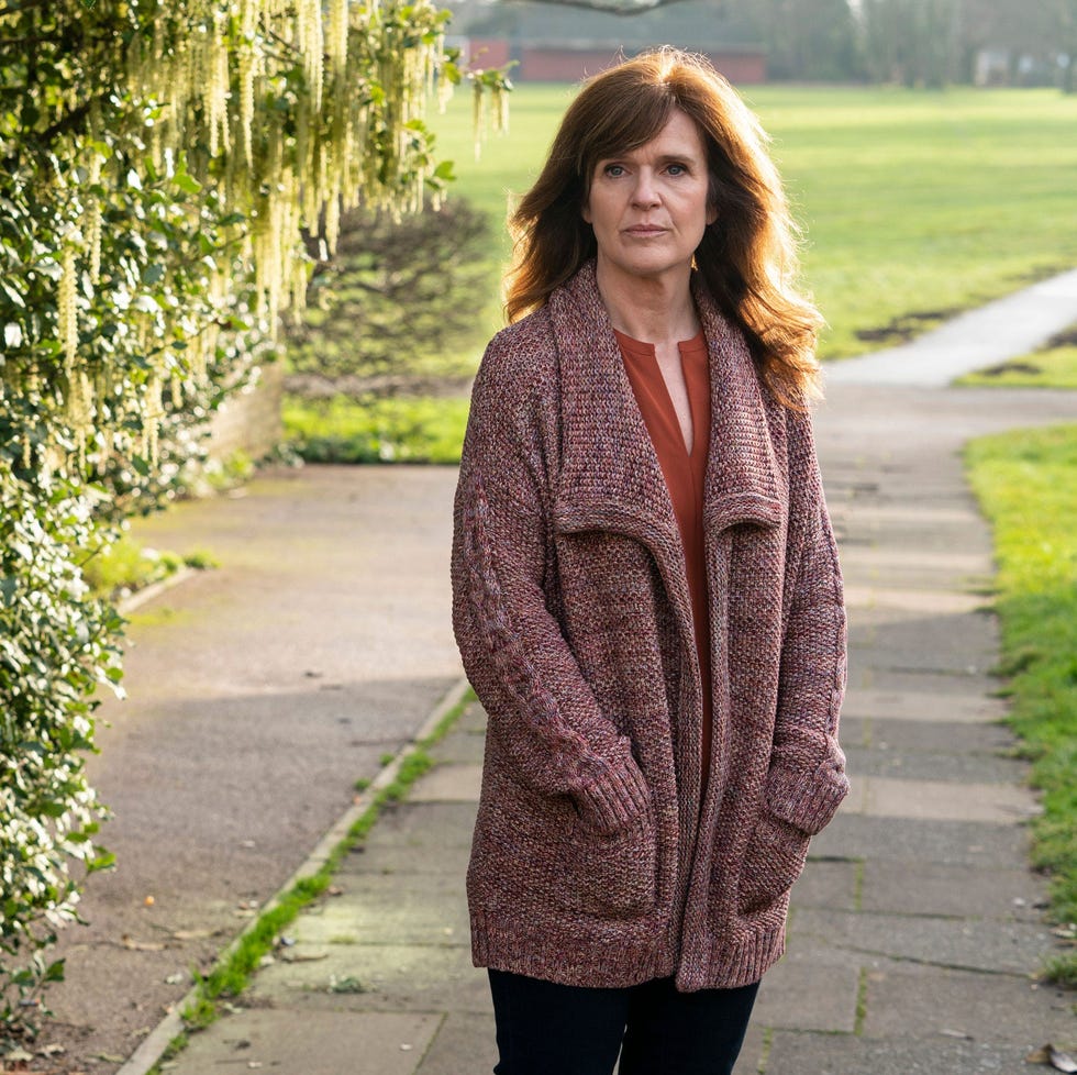 person standing near a walkway surrounded by greenery person standing near a walkway surrounded by greenery