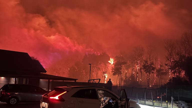 The blaze forced the evacuation of 22 homes overnight, though its cause remains unknown.