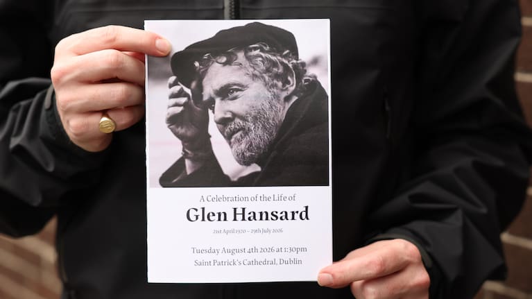 The Order of Service is held up ahead of the funeral of Glen Hansard at St Patrick's Cathedral in Dublin.