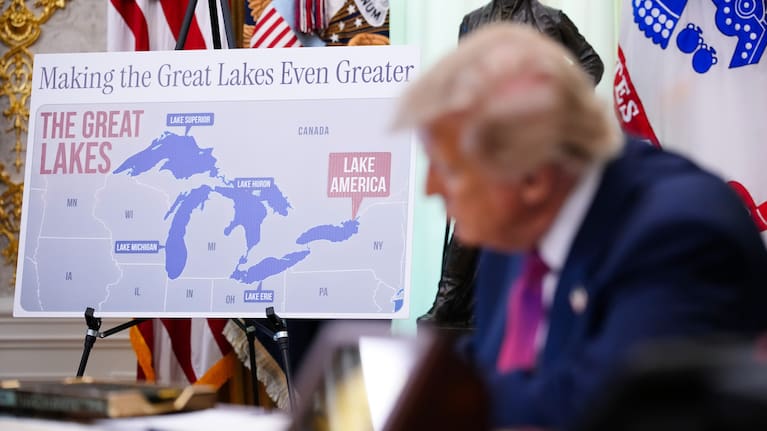 Trump signed the order in the Oval Office with a large sign in the background.